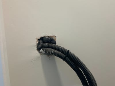 Cables left exposed at the wall — Bedroom