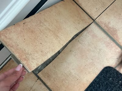 Floor tiles lifting at the doorway — Kitchen floor