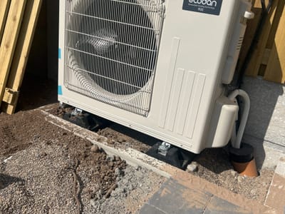 Heat pump standing on unfinished ground — Rear elevation