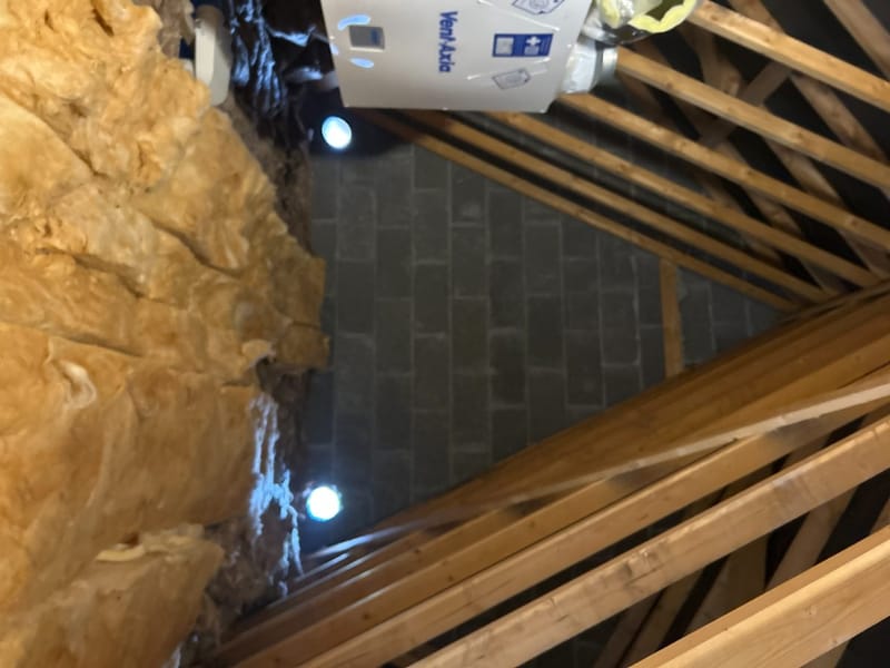 Attic inspected under torchlight, insulation stopping short of the eaves