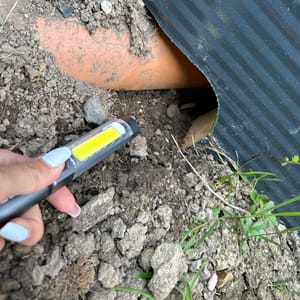 Torch held to a drainage pipe left unbedded under the membrane